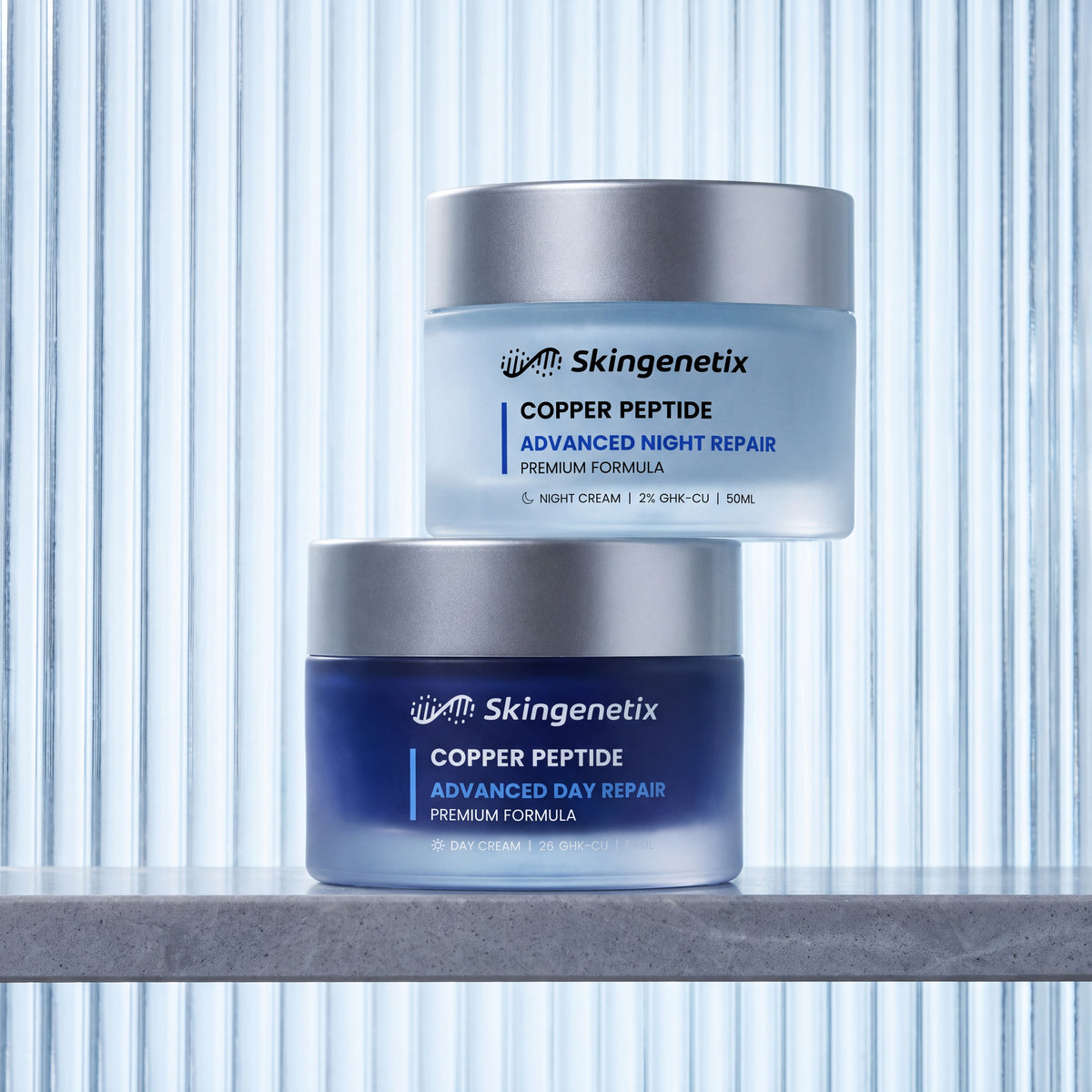 Skingenetix Day & Night Copper Peptide (GHK-Cu) Duo Set - the day and night creams in front of a backlit fluted glass panel