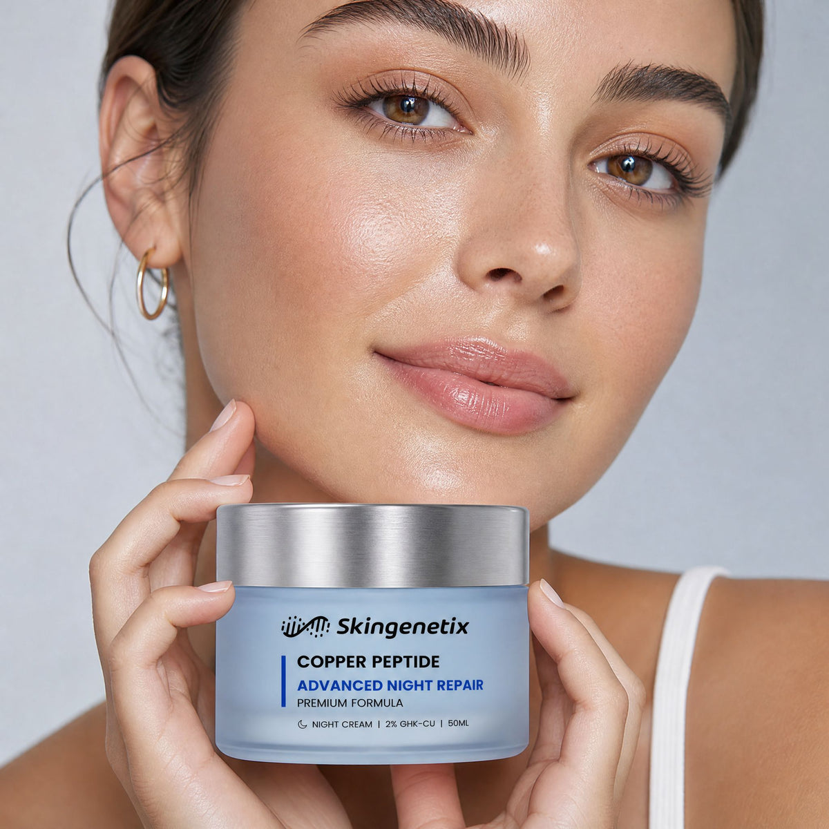 Skingenetix Copper Peptide (GHK-Cu) 2% Night Cream, 50ml - a model holding the jar beside their face