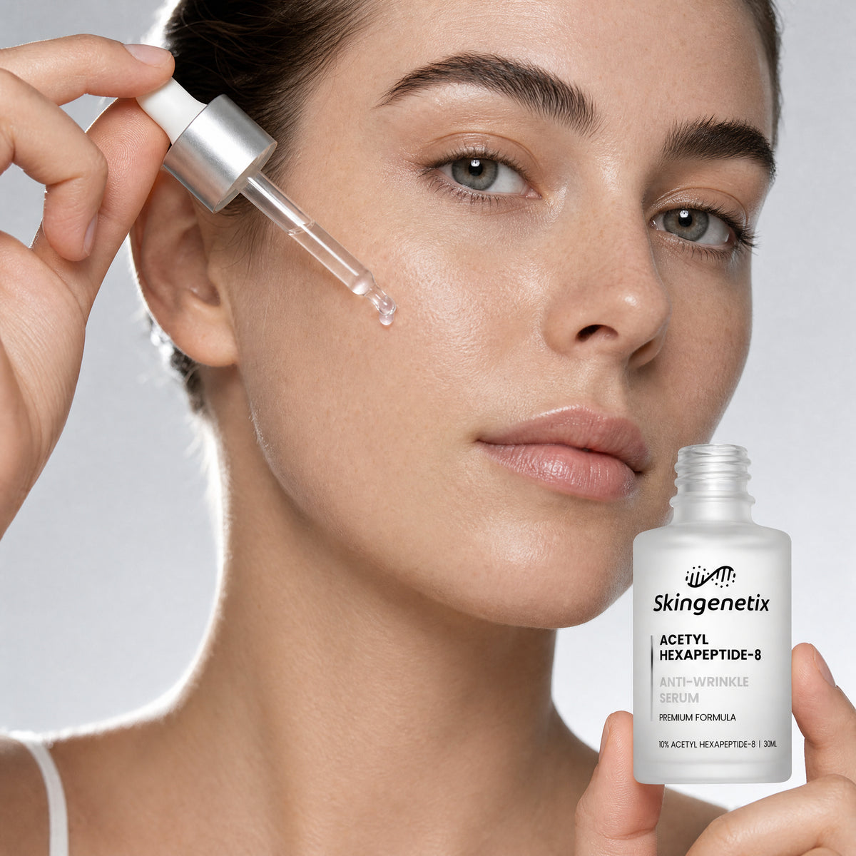 A model holding a 30ml frosted glass bottle of Skingenetix Acetyl Hexapeptide-8 Anti-Wrinkle Serum and releasing a drop from the glass dropper beside her cheek