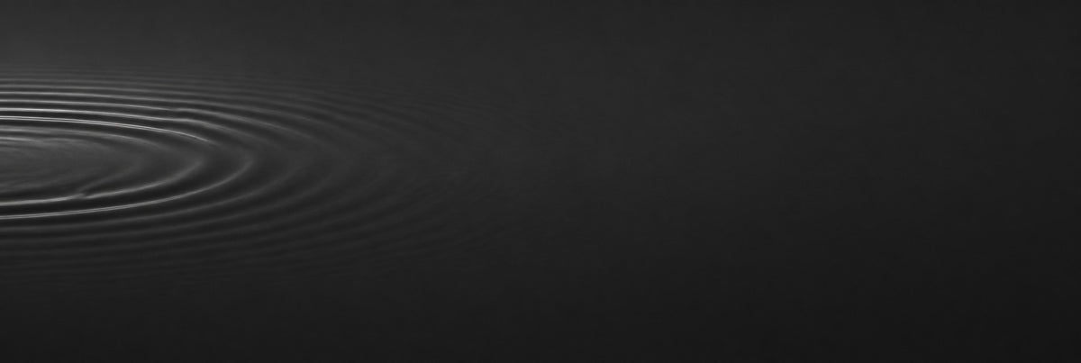 Ripples settling into a still, dark liquid surface, representing expression lines smoothing out