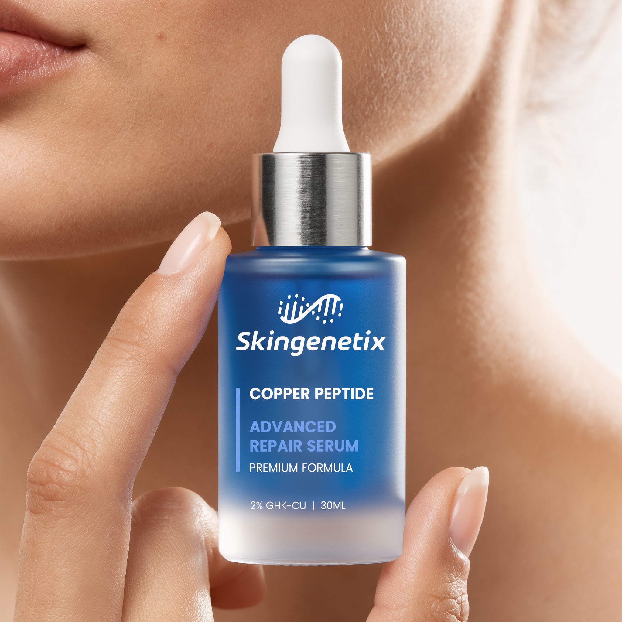 Woman holding a deep blue frosted glass bottle of Skingenetix Copper Peptide (GHK-Cu) 2% Renewal Serum, 30ml, up beside her cheek and jawline