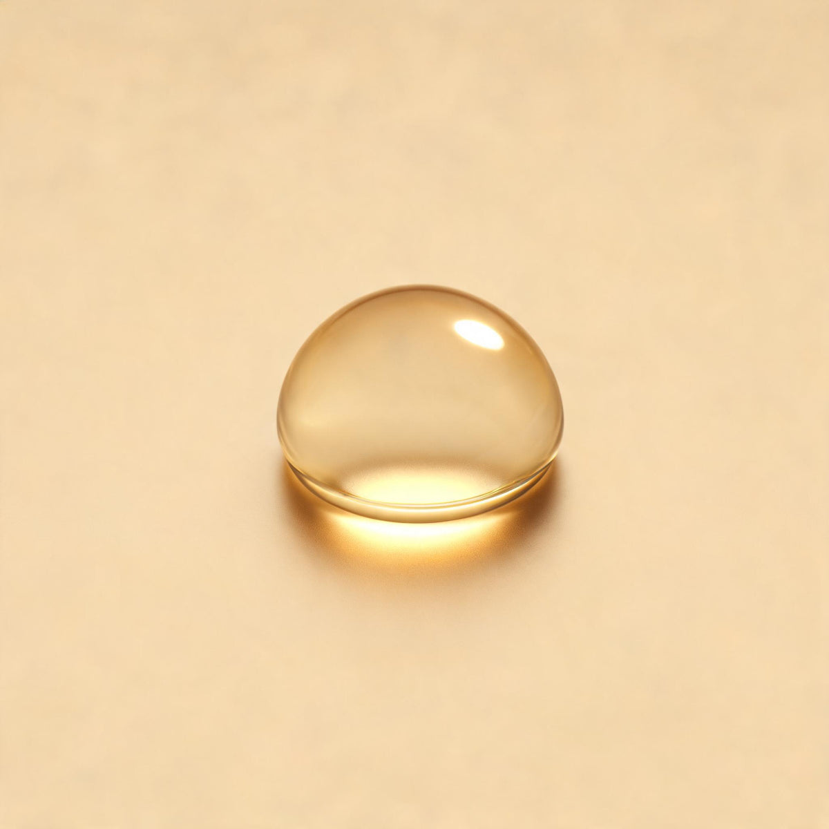 A golden drop of brightening oil on a champagne background - Skingenetix brightening and glow range
