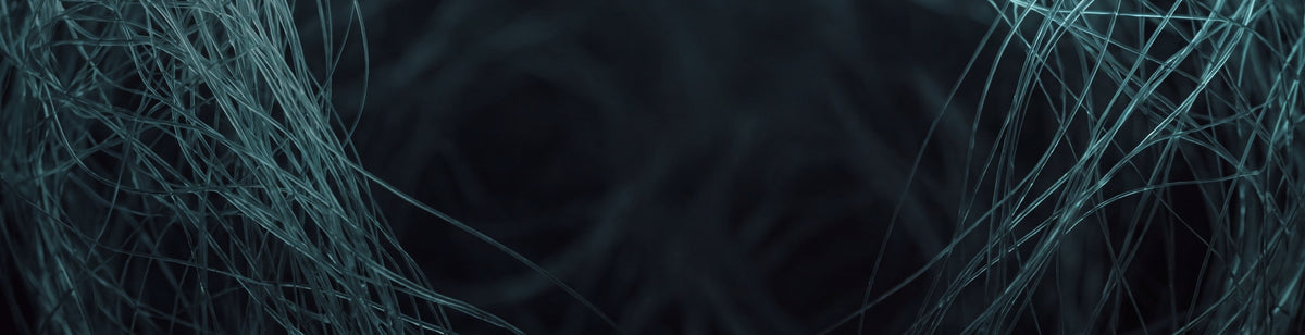 Teal collagen-like fibres crossing a dark ground, representing the skin's supporting matrix