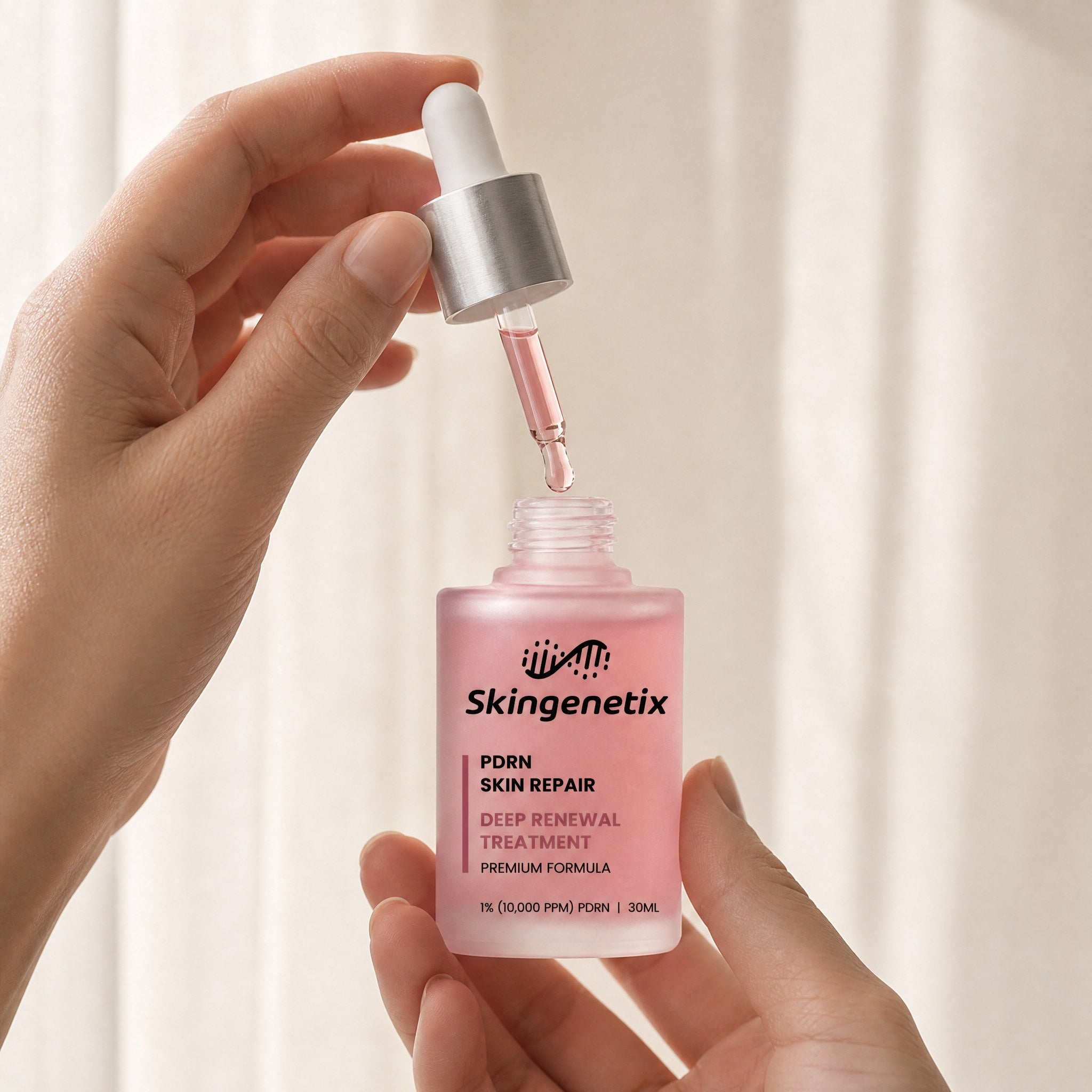 Skingenetix PDRN 1% Renewal Serum, 30ml - bottle held with the pipette lifted clear and a drop forming