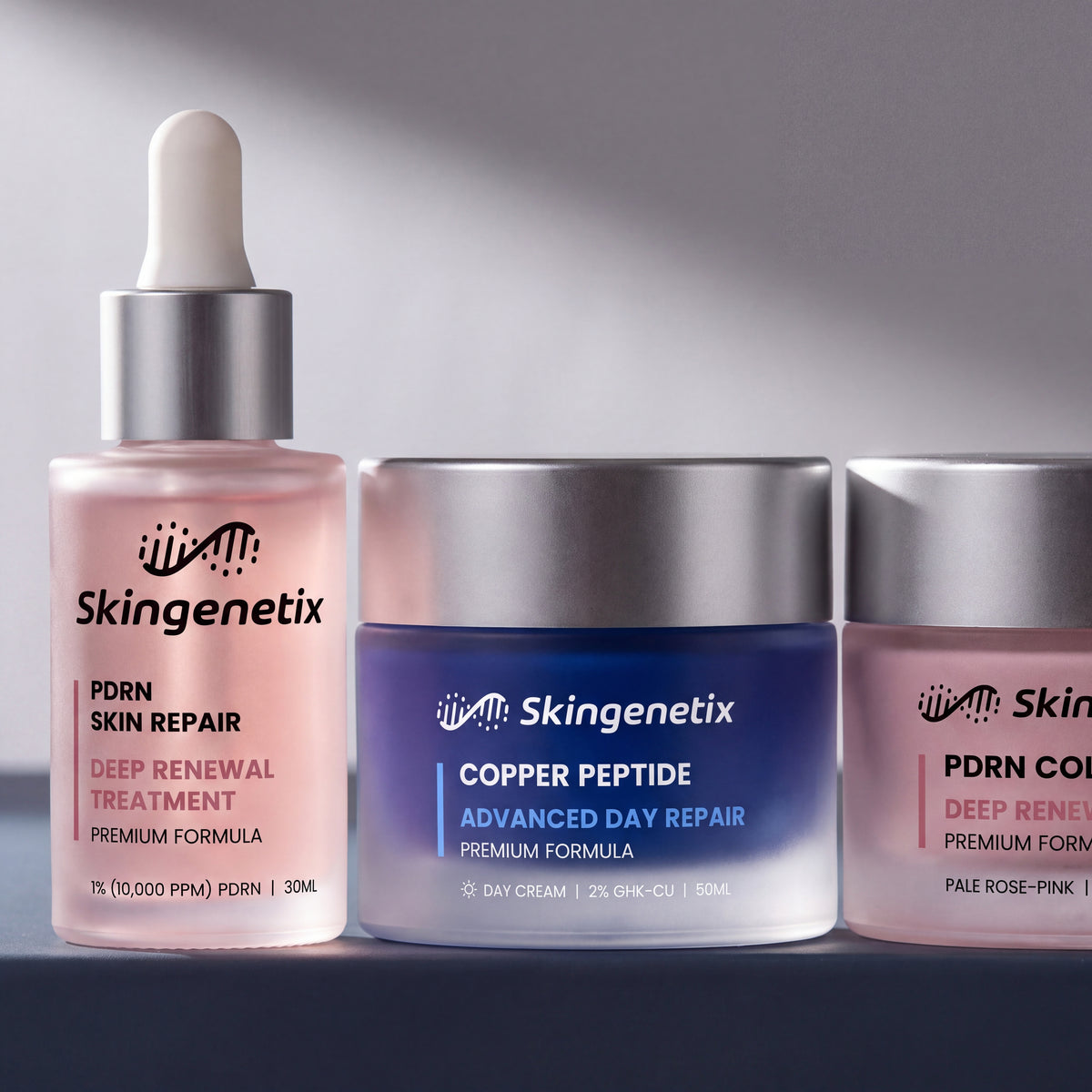 Skingenetix Complete Skin Repair & Renewal Day & Night Routine - a close group shot of the serum bottle between both cream jars