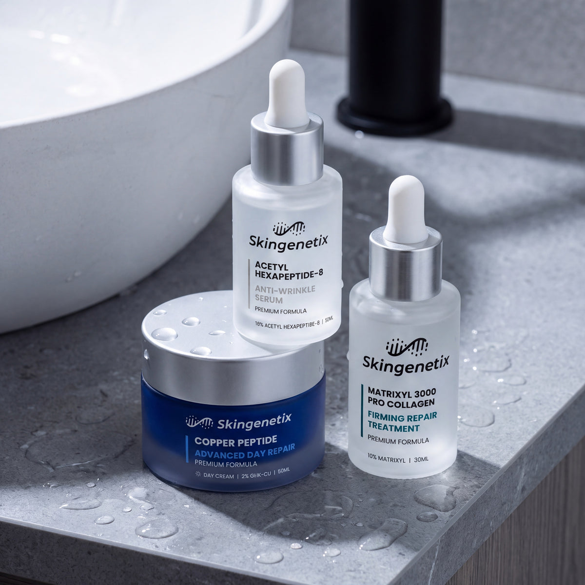 Skingenetix Complete Fine Lines & Wrinkles Routine - the two serums and the day cream on a stone basin rim scattered with water droplets