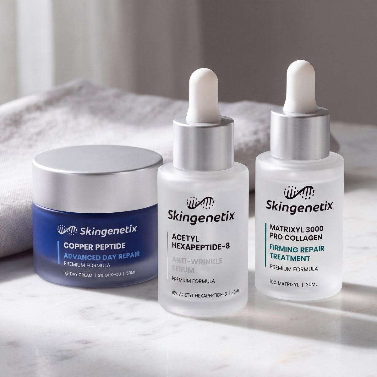 Skingenetix Complete Fine Lines & Wrinkles Routine - the copper peptide day cream in front of both serums on a pale marble surface